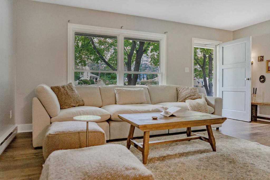 a living room with a couch and a coffee table at Game Day Haven With Bar & Deck in State College