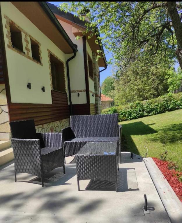 a table and chairs in front of a house at Vila in Rtanj