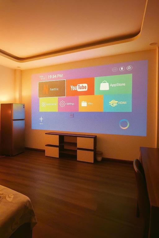 a room with a large screen with a tv at START HOUSE AIRPORT 5-MIN WALK Warm Stay, Easy Flight in Ho Chi Minh City