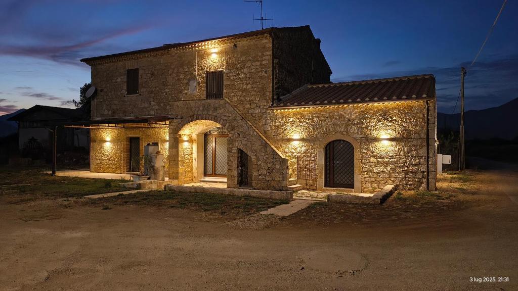 an old stone building with lights on it at L'Antico Borgo di Leonardo in Monte San Biagio
