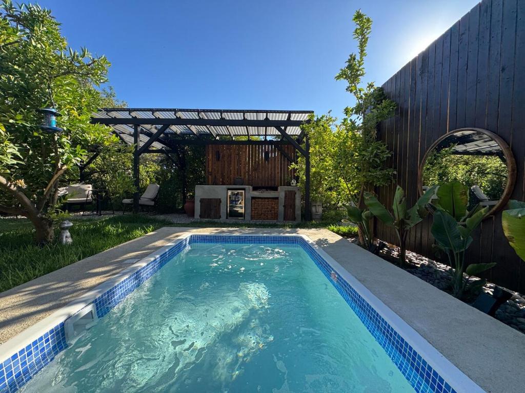 a swimming pool in the backyard of a house at Custom Tiny House in Valle in Francisco Zarco