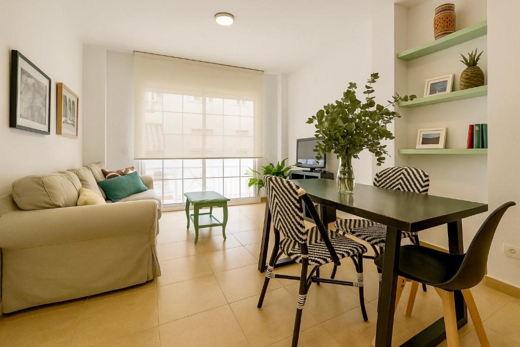 a living room with a table and a couch at Apartamento Ría Punta Umbría in Punta Umbría