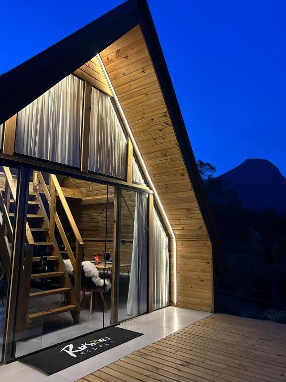 a house with a staircase on the side of it at Chalé aconchegante em madeira in Schroeder