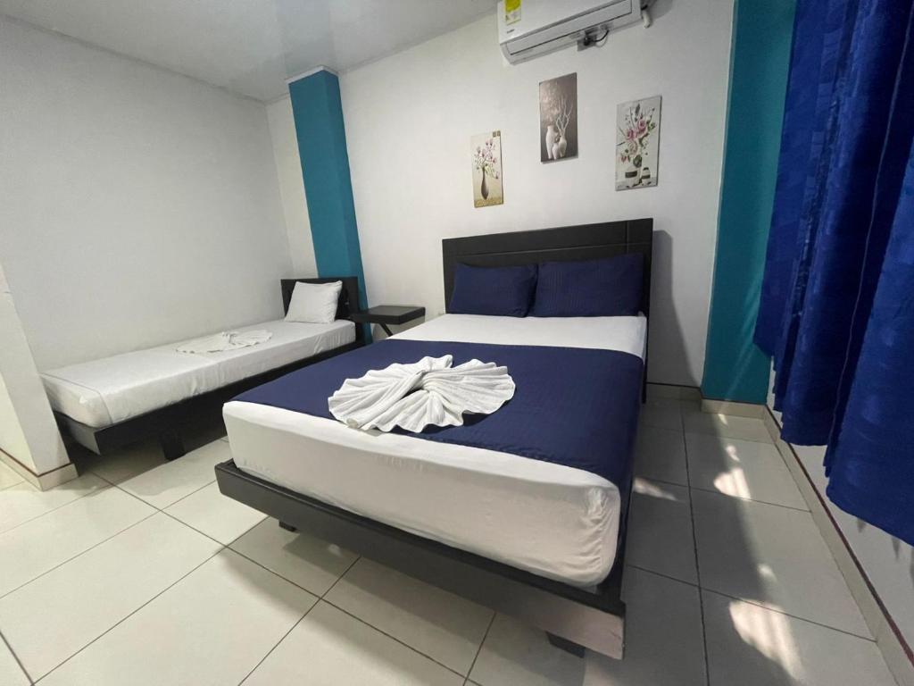 a bedroom with a large bed and a mattressvisor at Hotel Cayena in Tame