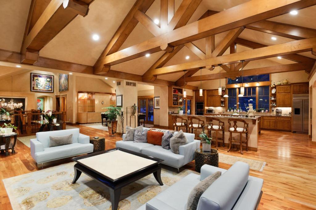 a living room with a couch and a table at Luxe Artful Mountain Retreat with 4 King Suites, 8 Person Hot Tub and 3 Decks in Carbondale