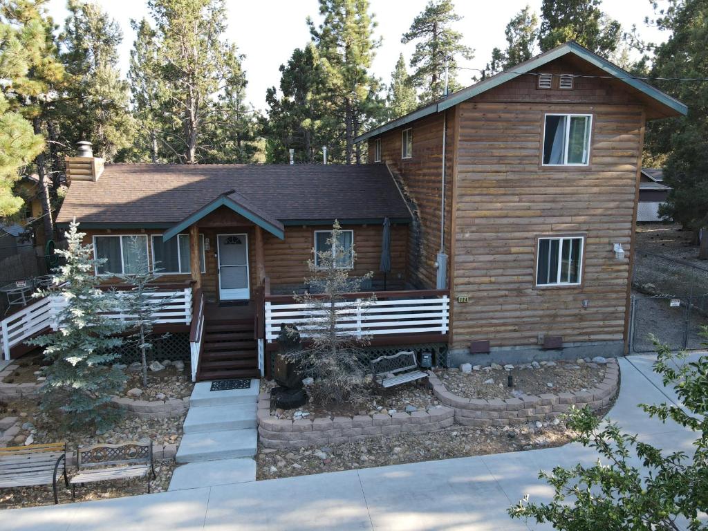 a log cabin with a porch and a house at Bear House in Big Bear City