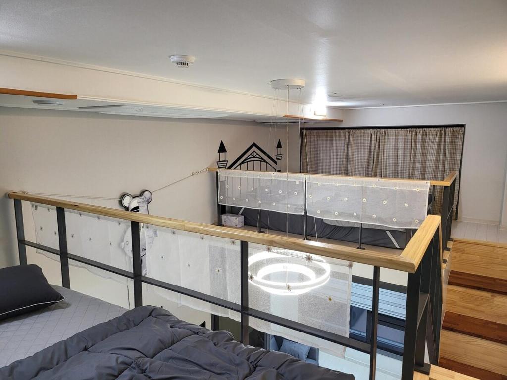 a bedroom with a bed and a balcony at Stay in Seoul