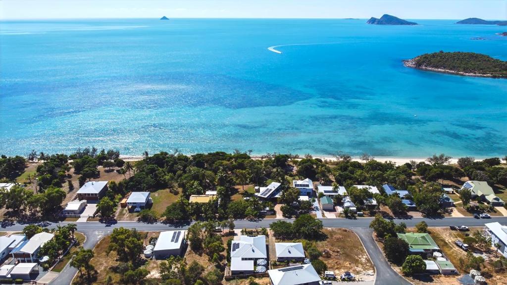 an aerial view of a beach with houses and the ocean at "Tranquillity by the Sea" your Hideaway Bay Holiday Rental-Whitsundays in Hideaway Bay