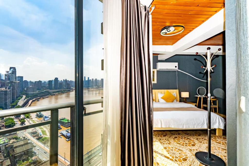 a bedroom with a bed and a view of a city at Jinxin Nanguo in Chongqing