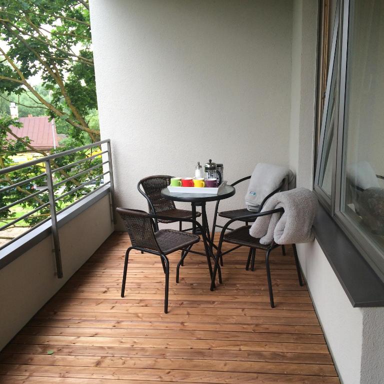 a small balcony with a table and chairs on it at Fortuuna 5 Apartment in Tartu