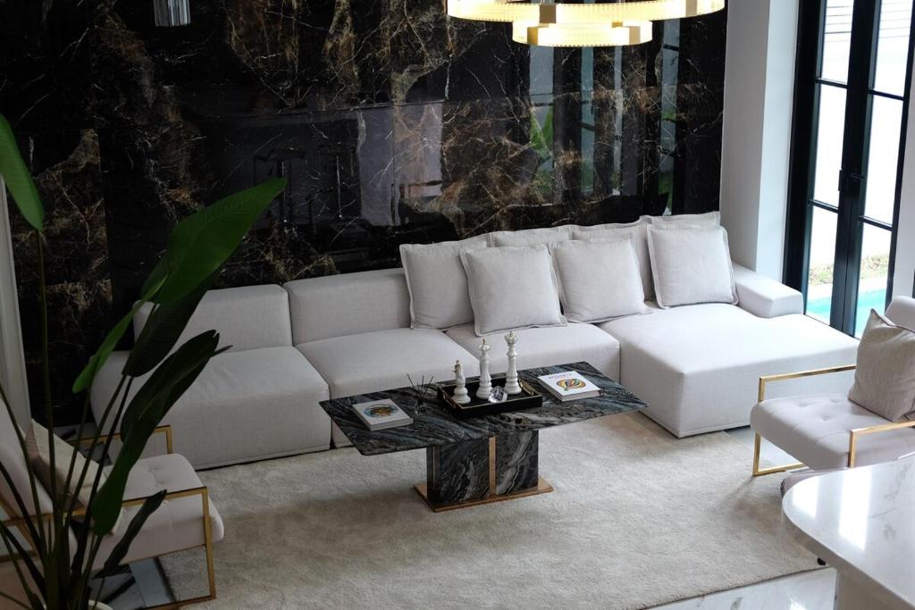 a living room with a white couch and a table at 5-Star Pool Villa 4BR Private Luxury-Sukhumvit in Ban Nong Chaeng