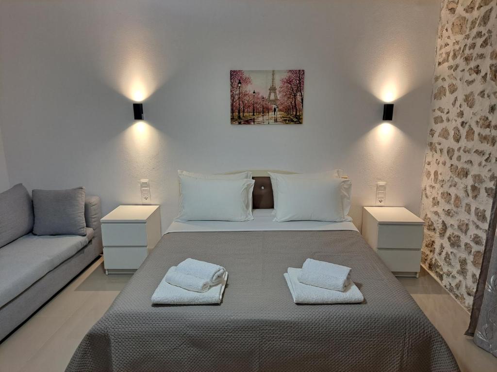 a small bedroom with a bed and a couch at Dea's Garden home in Himare