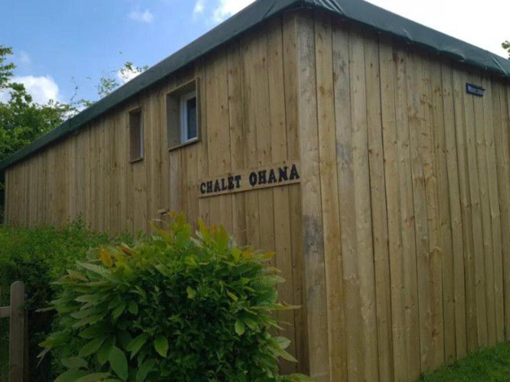 a wooden building with a sign on the side of it at Chalet 50m², 8 personnes, Terrasse - API-1-52-723 in Les Grandes-Ventes