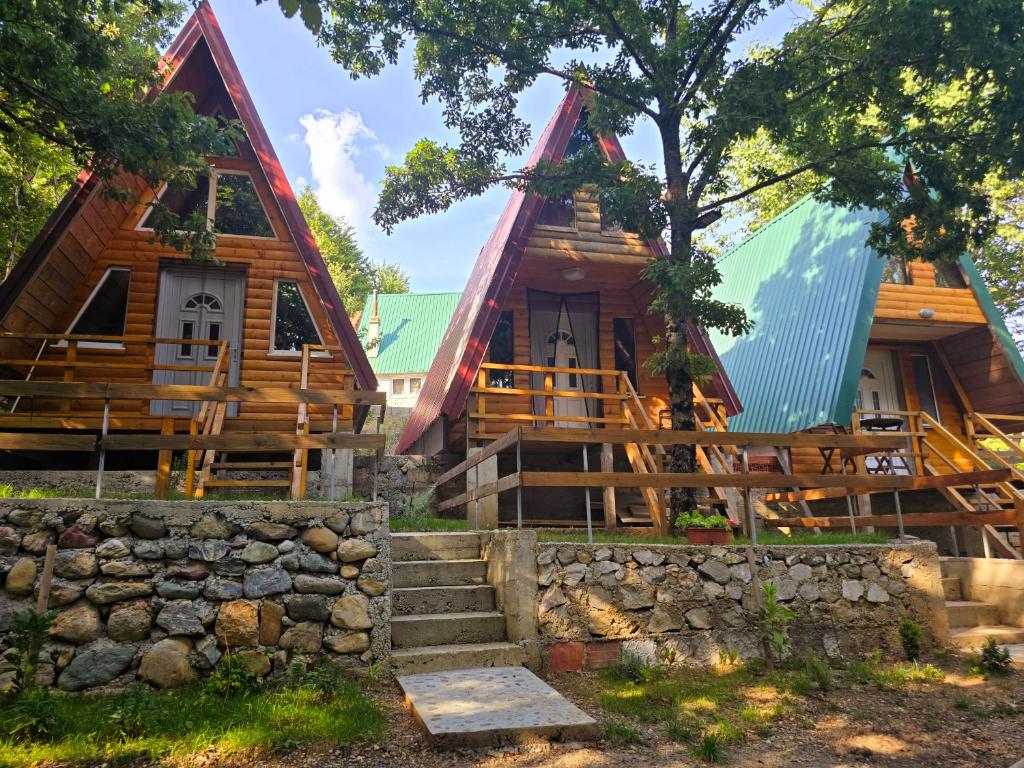 a log cabin with a green roof at Tri breze in Kolašin