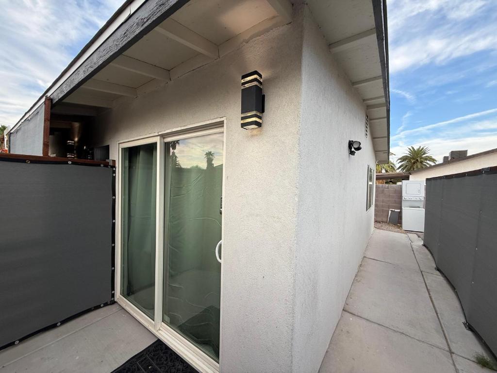 a white building with a sliding glass door at Cozy Guest House in amazing Las Vegas in Las Vegas