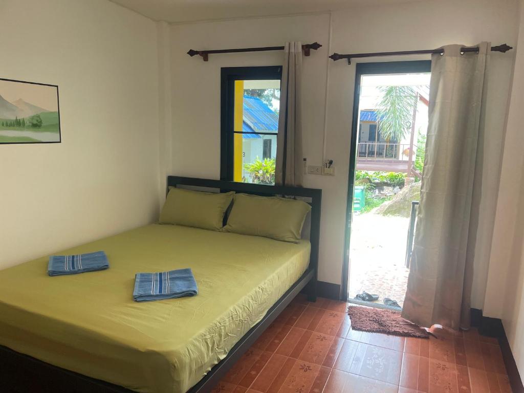 a bedroom with a bed with two towels on it at Lonely Beach Pool Resort in Ko Chang