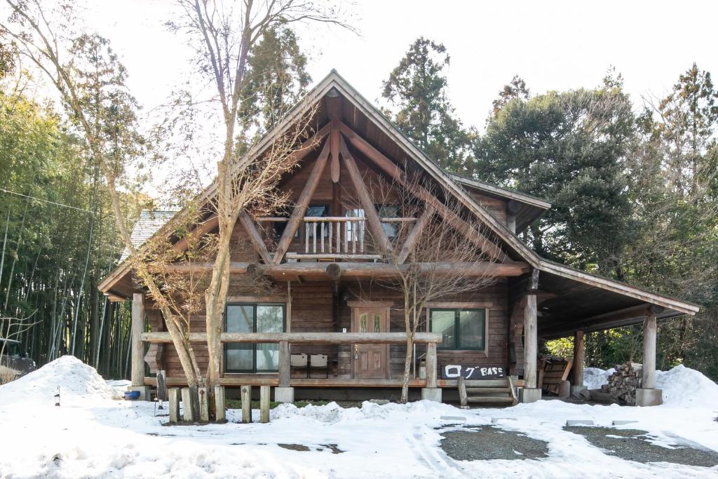 a log cabin in the snow at ログbase in Kaga