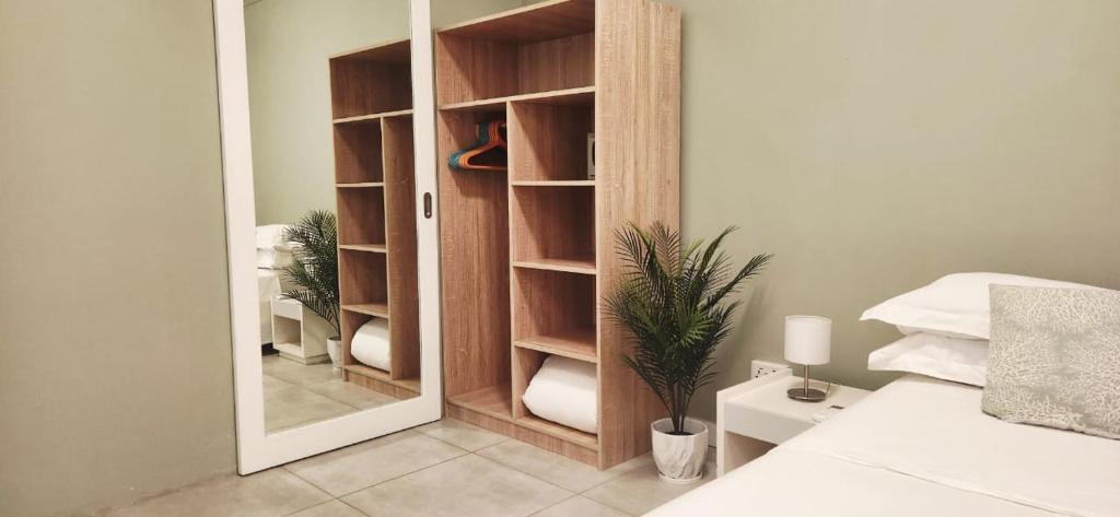 a closet with a mirror in a bedroom at The Beach Life Pereybere in Pereybere