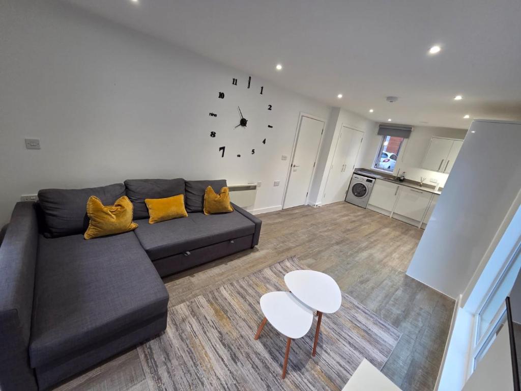 a living room with a couch and a table at City Haven, Luxury 2-Bed, 2-Bath City Centre Flat with Gym & Garden - Steps from Cruise Terminal in Southampton
