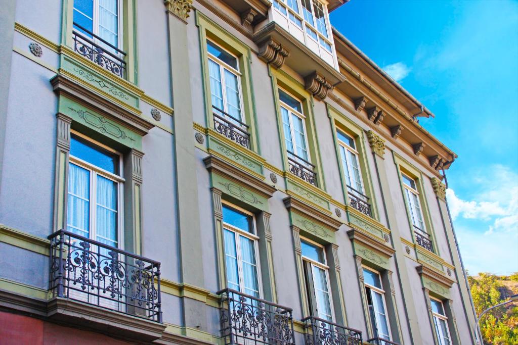 a building with windows and balconies on it at Hotel La Colmena in Luarca