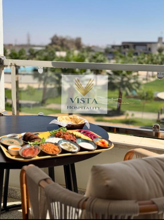 a tray of food on a table on a balcony at Vista Hotel Tabuk in Tabuk