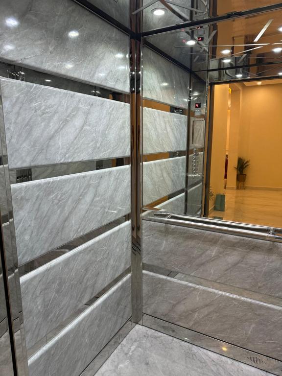 a wall of metal panels in a building at Shaleeh 285 شاليه العائلة in Al Khīrān