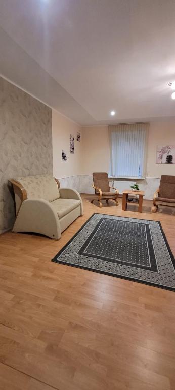 a living room with a couch and a rug at Iranija 21 in Daugavpils