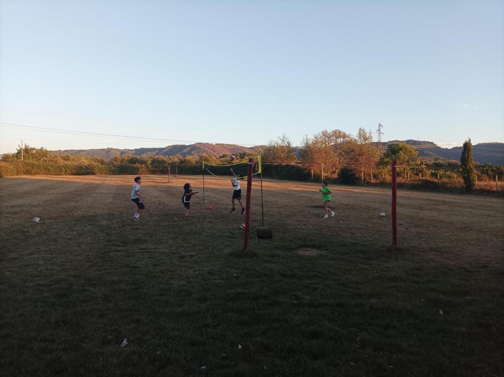 a group of people playing soccer in a field at Agriturismo - fattoria didattica Caratozzolo 