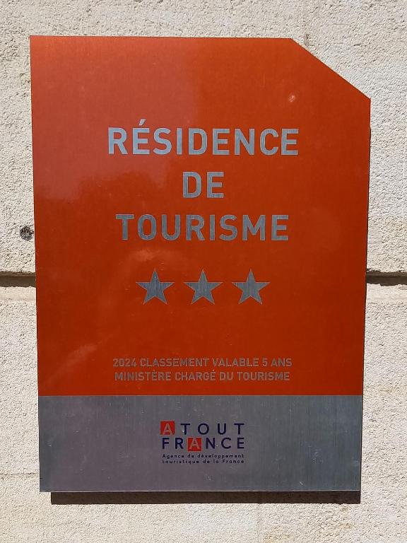 a sign on the side of a wall with stars at Résidence de Tourisme Vacances Bleues Villa Regina in Arcachon