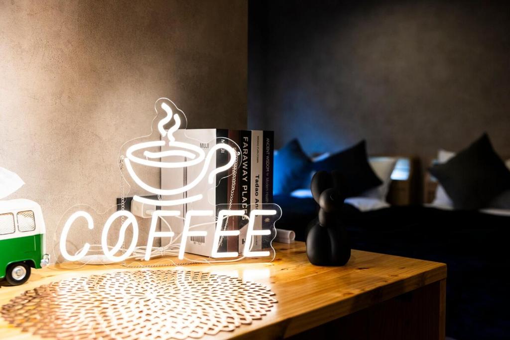 a coffee sign on top of a wooden table at tomarutoko OGUSU in Fukuoka