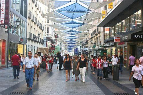 a group of people walking down a busy city street at Loft ubicado junto a Madrid in Móstoles