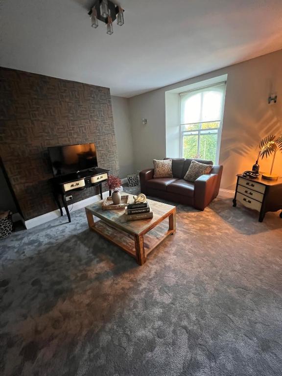 a living room with a couch and a coffee table at Cherry Blossom Loft in Harrogate