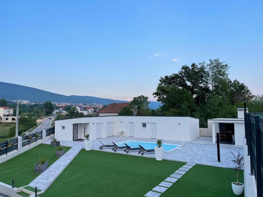 a large backyard with a pool and grass at Casa La Familia in Posušje