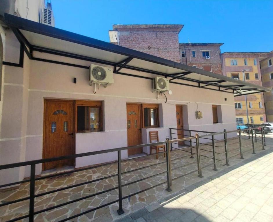 a building with awnings on the side of it at Cozy Apartments Permet in Përmet