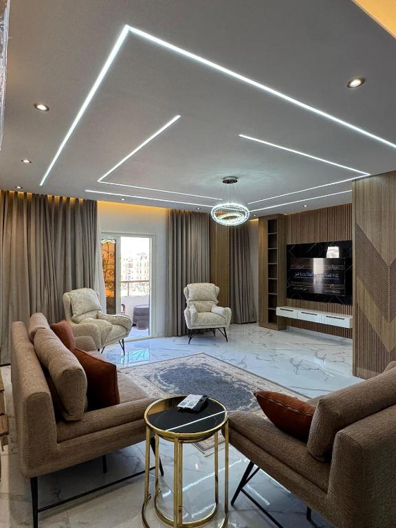 a large living room with couches and a tv at Luxury appartment New Cairo in New cairo
