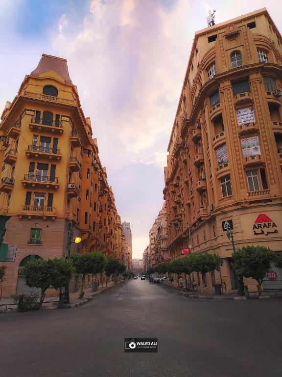 an empty street with two tall buildings on the side at Excellent Location cairo in Cairo