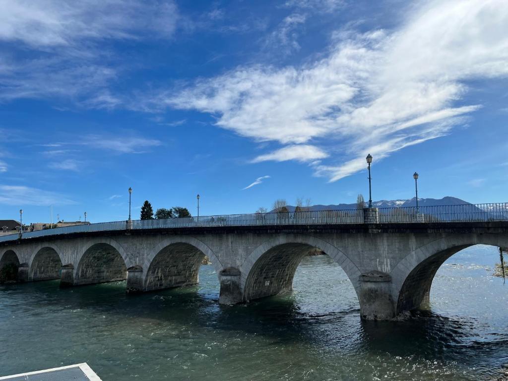 a bridge over a body of water at LE BERCHON classé trois épis in Nay