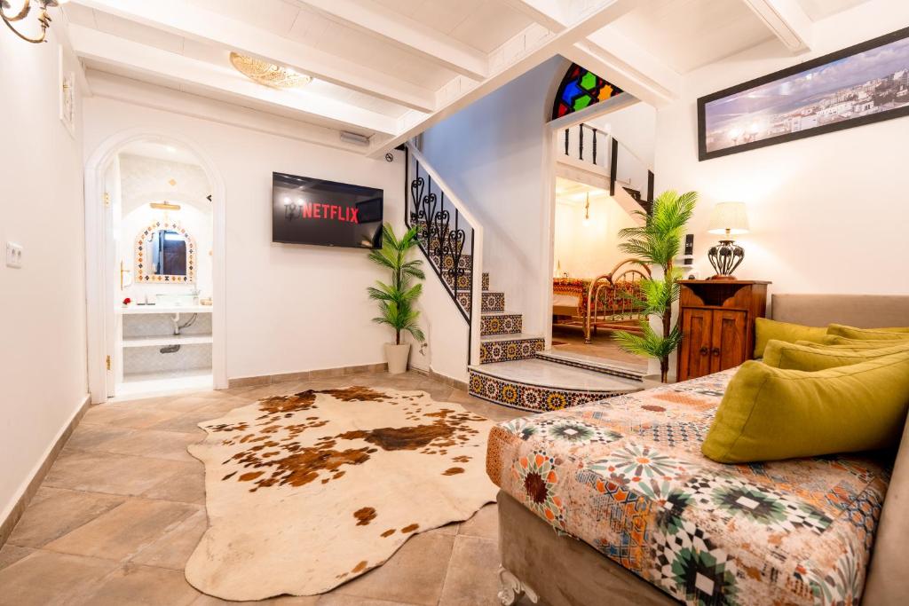 a living room with a couch and a staircase at Kasbah Dream - Great Location in Tangier in Tangier