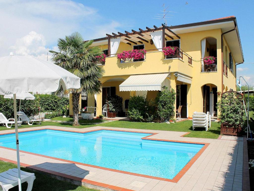 a house with a swimming pool in front of a house at Holiday Home in Lazise near Lake Garda in Lazise