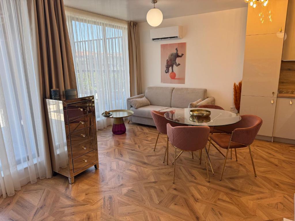 a living room with a couch and a table at Azur by Gergana in Bŭnzareto