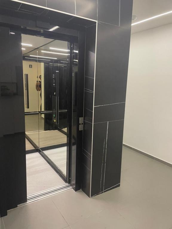 a door in a room with a mirror at Citysmart Apartment in Tuzla