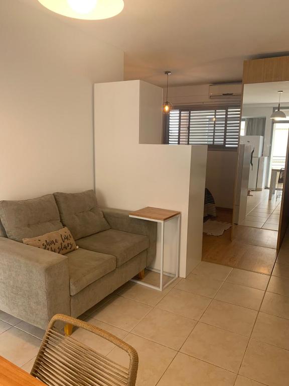 a living room with a couch and a table at Departamento céntrico in Rosario