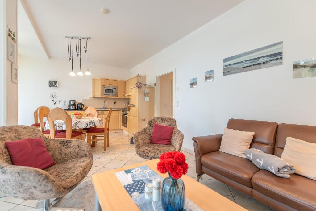 a living room with a couch and chairs and a table at Haus Südwind, App 18 in Zempin
