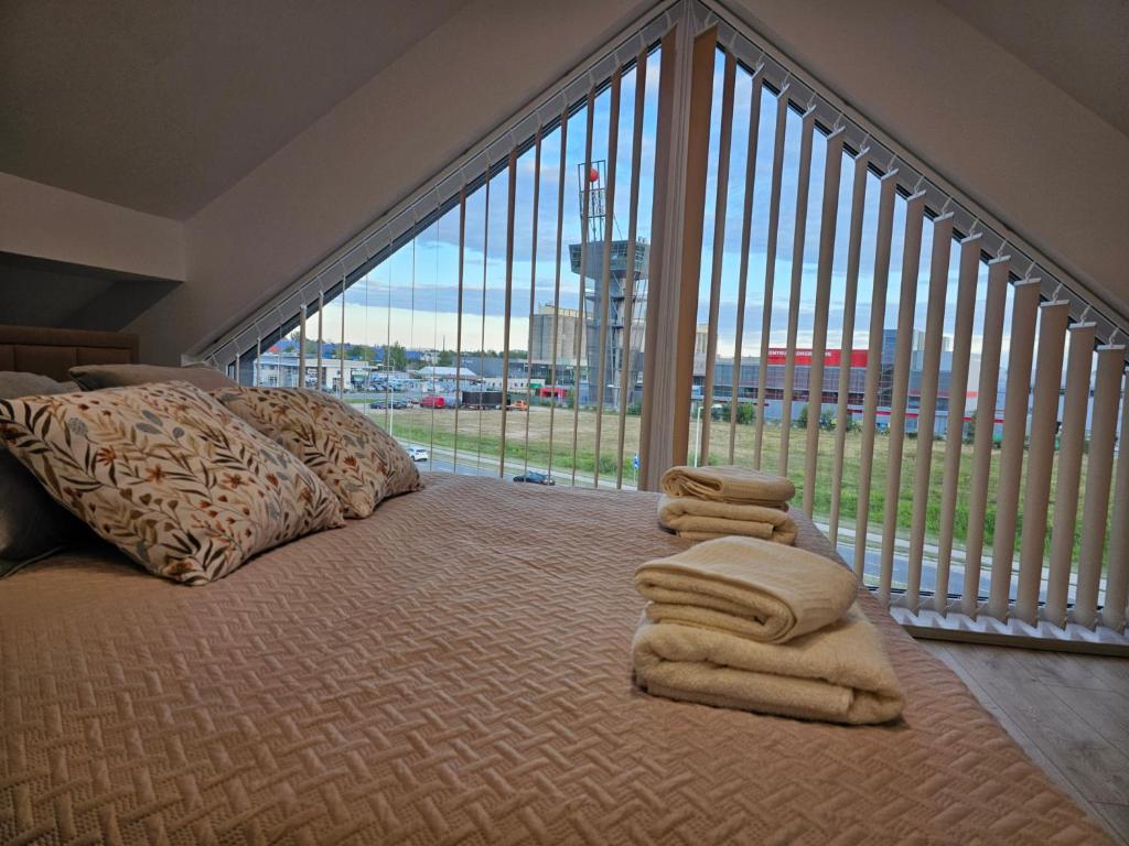 a bedroom with a large bed with towels on it at Apartament KONGRESOWA VIEW in Kielce