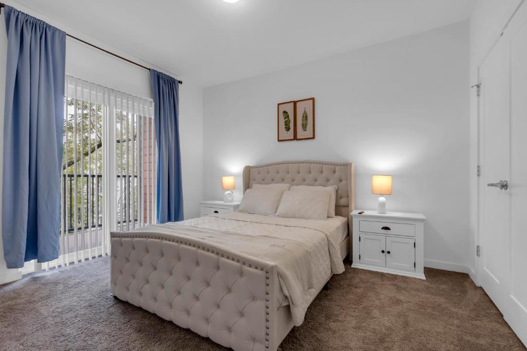 a white bedroom with a large bed and a window at Downtown Atlanta Home Away from Home - 2 in Atlanta