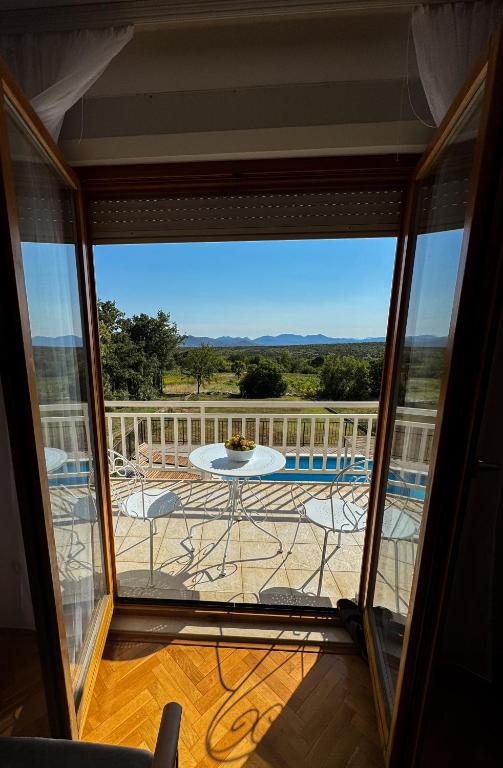 a view of a balcony with a table and a patio at Olives Garden in Čitluk