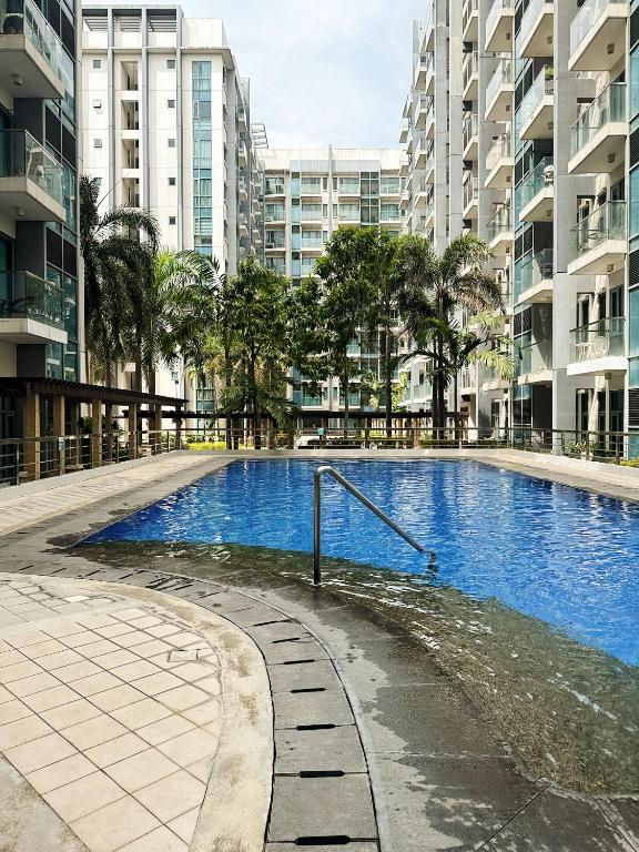 a swimming pool in a city with tall buildings at Kai cabins NAIA 3 walking distance Newport City Pasay in Manila