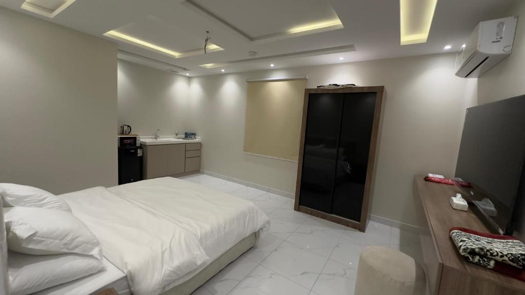 a bedroom with a bed and a bathroom with a sink at نايس لوكيشن in Taif