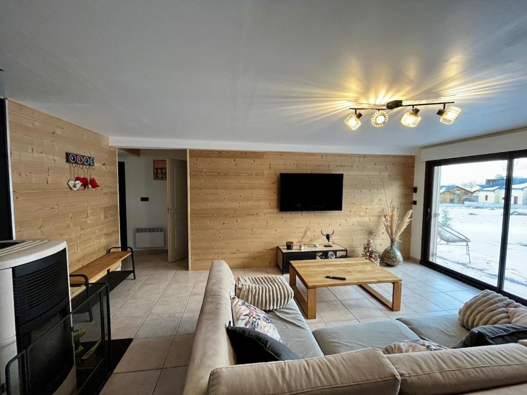 a living room with a couch and a table at La Jassette 7 in Saint-Pierre-dels-Forcats