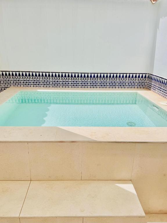 a large swimming pool in a white room with at Casa Ramón in Vélez-Rubio